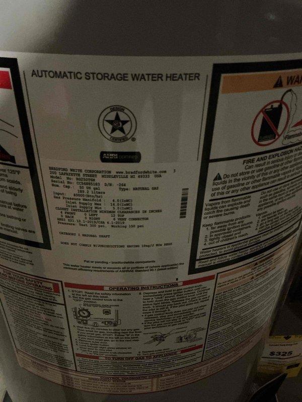 Completed installation of a 50-gallon Bradford White natural gas water heater in basement utility area. Unit was installed with proper copper supply line connections, gas line hookup, temperature and pressure relief valve, and all required safety controls per manufacturer specifications and local code requirements.