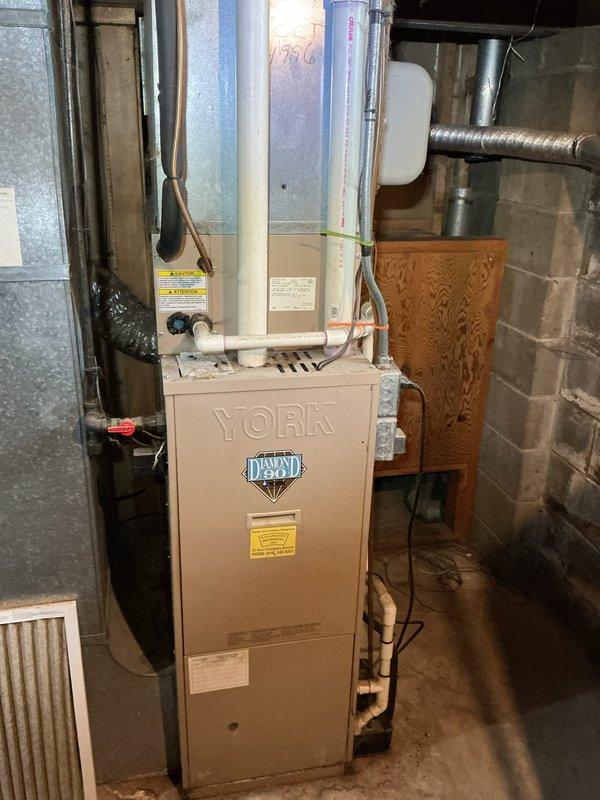 Completed annual cooling maintenance on 30-year-old York air conditioning system. Performed comprehensive tune-up including inspection of all major components, electrical connections, and system operation. Evaluated refrigerant charge per customer request from previous service recommendation; assessed system pressures and temperatures. Documented equipment condition with photos of furnace and mechanical room setup. System operational at time of departure.