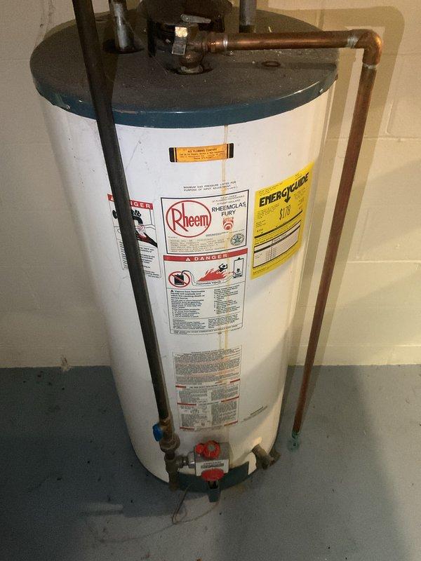Responded to service call for leaking pressure relief valve on approximately 35-year-old Rheem water heater. Upon inspection, confirmed PRV leak and assessed overall condition of aging unit with worn copper connections and fittings. Provided estimate for complete water heater replacement due to age of existing equipment and customer's preference to replace rather than repair the failing component.