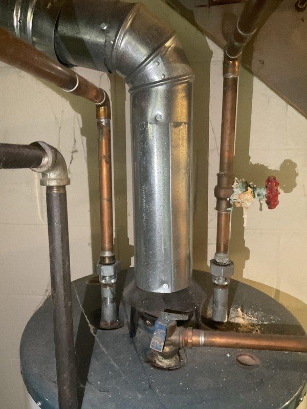 Responded to service call for leaking pressure relief valve on approximately 35-year-old Rheem water heater. Upon inspection, confirmed PRV leak and assessed overall condition of aging unit with worn copper connections and fittings. Provided estimate for complete water heater replacement due to age of existing equipment and customer's preference to replace rather than repair the failing component.