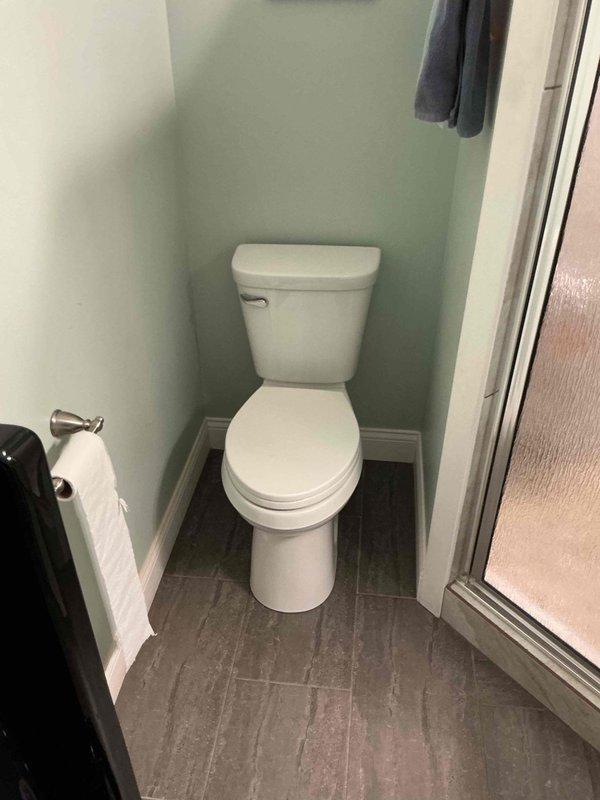 Completed toilet replacement due to cracked tank. Removed existing fixture, prepared flange and floor surface, and installed new two-piece white ceramic toilet with proper wax ring seal and secure mounting. Verified proper operation and left bathroom clean and functional.