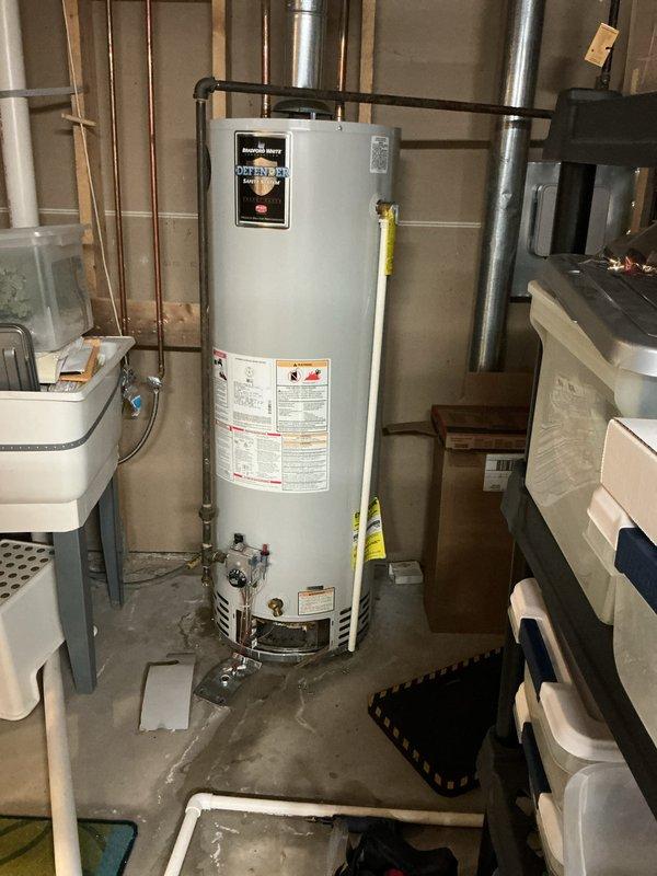 Responded to no hot water and leaking water heater call. Upon arrival, inspected unit and surrounding area in basement utility room. Confirmed active leak at base of water heater with visible water staining on concrete floor beneath unit. Assessed overall condition of tank, plumbing connections, and associated copper piping. Documented equipment condition and leak source with photographs for customer records.