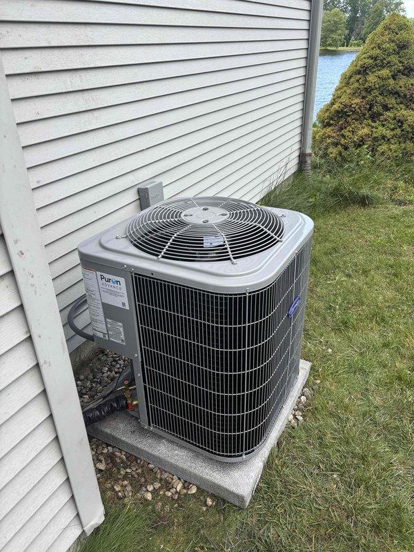 Completed full HVAC system installation including new furnace and air conditioning unit. Installed gray furnace in mechanical room with proper PVC condensate drainage and intake/exhaust piping, connected to galvanized metal ductwork with flexible couplings, and mounted all necessary electrical controls and components. Installed Payne brand outdoor condenser unit on concrete pad with proper gravel base, ran electrical conduit through exterior wall, and verified all connections for proper system operation.
