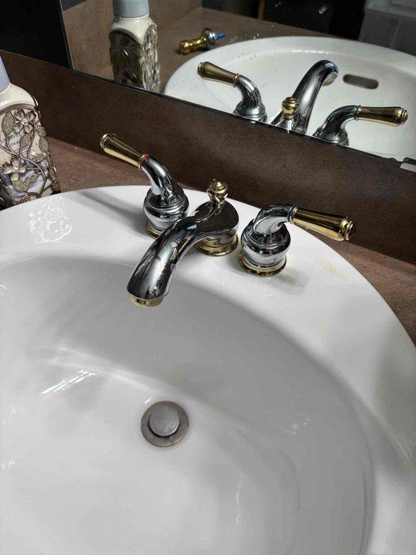 Responded to service call for dripping master bathroom sink in upstairs location. Upon inspection, identified leak at faucet assembly on dual-sink vanity setup with chrome and brass-toned three-piece faucet fixtures. Performed necessary repairs to eliminate dripping condition and replaced existing shower head as requested. Verified proper water flow and confirmed no leaks upon completion of work.