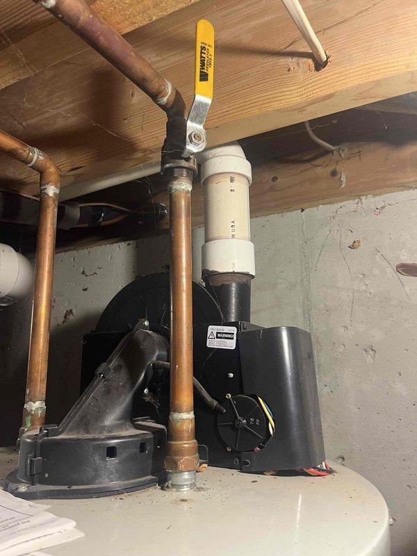 Conducted water heater replacement estimate at residential property. Customer requested evaluation for replacement purposes with no immediate operational issues reported. Documented existing water heater installation in basement utility area, including copper supply piping with shut-off valves, water treatment system components, and current mechanical configuration. Photographed equipment and surrounding plumbing infrastructure to provide accurate replacement specifications and pricing options.