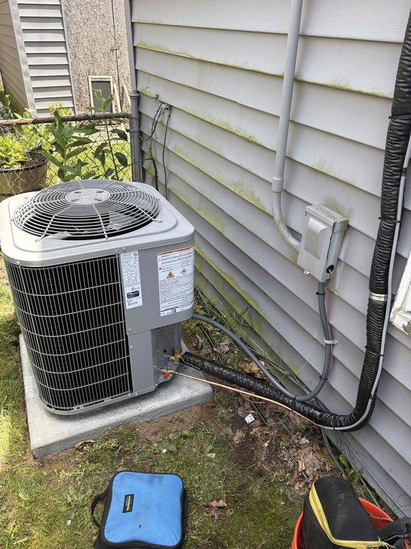 Completed full system installation of furnace, air conditioning unit, and water heater. Installed outdoor AC condenser unit on concrete pad with proper refrigerant line routing along exterior siding, secured with mounting clips. System charged with flammable refrigerant R-32, with initial charge of 3.72 lbs and added charge of 5.3 lbs to manufacturer specifications. All components tested and operational upon completion.
