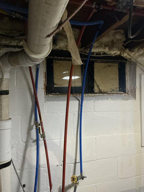 Completed plumbing club inspection for tub-to-shower diverter malfunction. Inspected basement plumbing infrastructure including PVC drain lines, PEX hot and cold water supply lines, and associated fixtures in utility area adjacent to laundry room. Documented existing plumbing configuration with photos showing vertical supply runs and overhead drainage system. Customer was informed of findings and aware of adjusted arrival time for inspection.