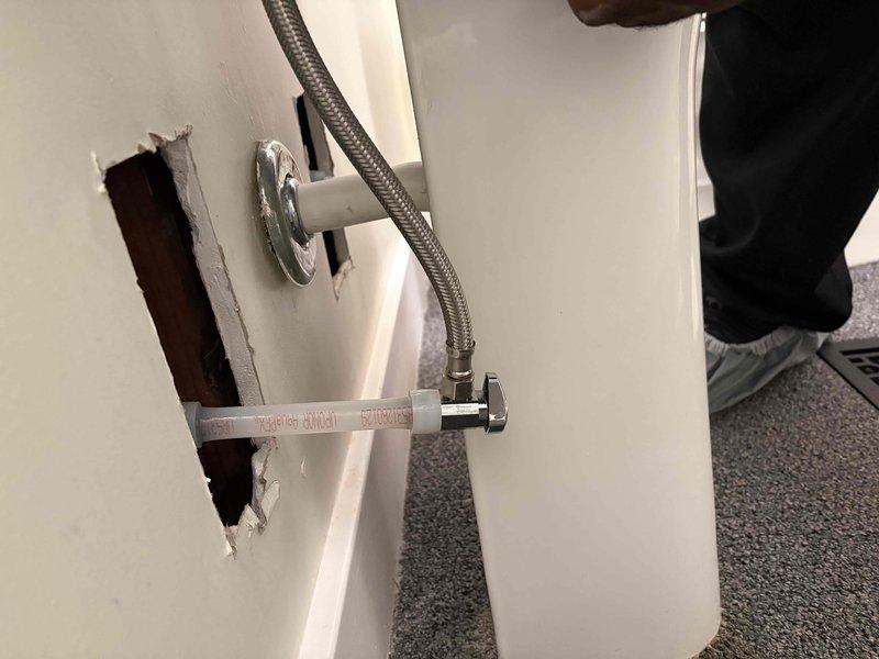 Responded to service call regarding protruding water supply lines that were preventing drywall repair completion. Cut down previously installed service lines by 6 inches to bring them flush with wall framing, allowing drywall contractor to proceed with repairs. Verified braided stainless steel flexible supply lines and chrome valve fittings remained properly secured and functional after modification.
