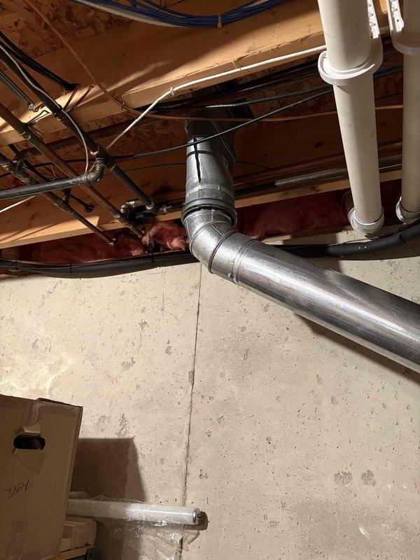 Conducted water heater estimate for residential property requiring replacement of large floor-mounted tank unit. Assessed existing installation location in basement area with exposed joists, documented current plumbing configuration including metallic supply lines and PVC drainage systems, and photographed infrastructure conditions to prepare replacement specifications. Confirmed customer contact information for scheduling future installation work.