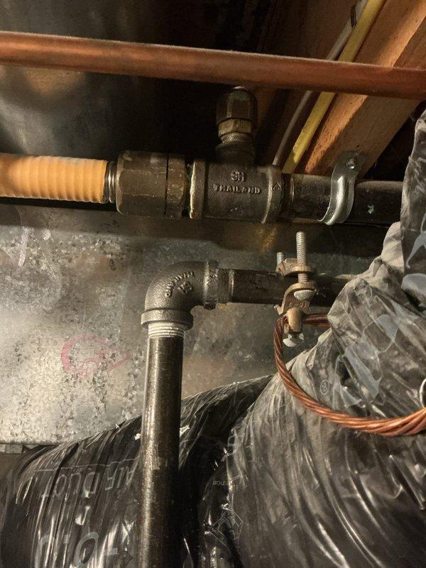 Responded to gas odor complaint occurring after shower use with CO2 alarm activation. Inspected 20-year-old A.O. Smith ProMax water heater and two Energi Air furnaces. Located and addressed gas leak at brass ball valve connection point on yellow corrugated flexible gas line serving water heater. Verified proper operation of gas shut-off valve, inspected all copper supply lines, galvanized venting, and gas piping connections throughout utility space. Conducted leak detection testing and confirmed system integrity upon completion.