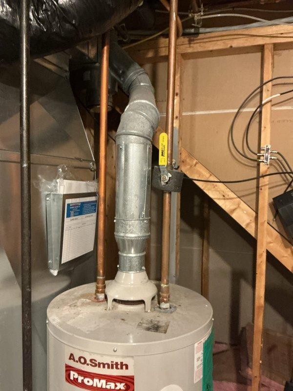 Responded to gas odor complaint occurring after shower use with CO2 alarm activation. Inspected 20-year-old A.O. Smith ProMax water heater and two Energi Air furnaces. Located and addressed gas leak at brass ball valve connection point on yellow corrugated flexible gas line serving water heater. Verified proper operation of gas shut-off valve, inspected all copper supply lines, galvanized venting, and gas piping connections throughout utility space. Conducted leak detection testing and confirmed system integrity upon completion.