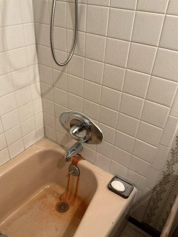 Completed shower valve and faucet replacement in residential bathroom. Replaced existing tub/shower valve assembly with new fixtures, including installation of chrome tub spout, diverter valve, and shower head with flexible metal hose. Flushed water lines to clear sediment and discolored water from system following valve replacement. Under-sink plumbing inspected and confirmed proper operation of supply lines and shut-off valves.