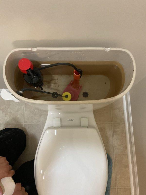 Responded to service call for non-functioning toilet. Upon inspection, found issues with internal tank components including fill valve and flush mechanism with discolored water present in tank. Diagnosed problem, performed necessary repairs to restore proper toilet operation, and verified system was functioning correctly before completing service.