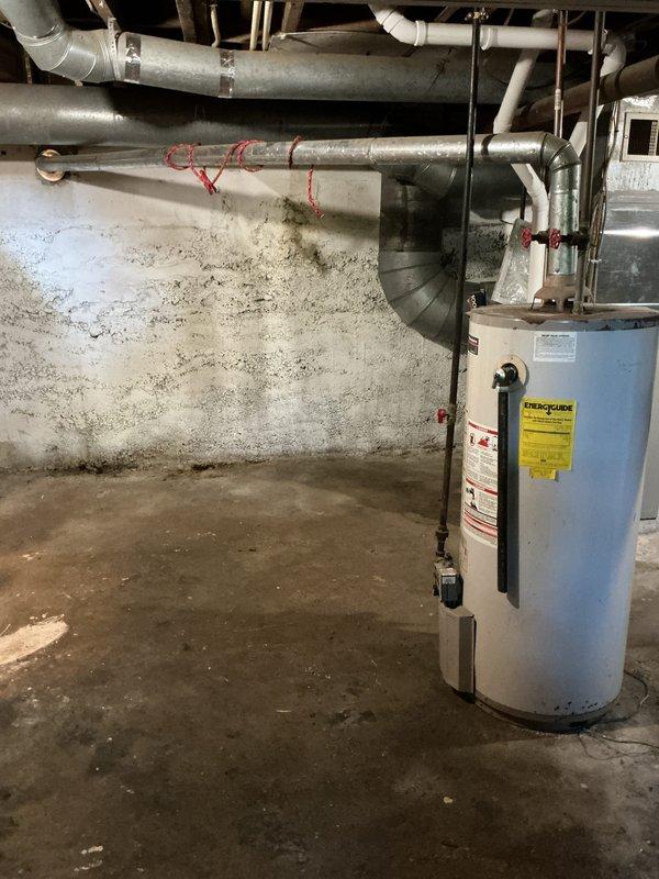 Completed water heater replacement estimate for a 16-year-old residential unit located in basement utility area. Assessed existing water heater configuration including copper supply lines, red-handled shut-off valves, PVC venting, and connection points to building infrastructure. Documented current installation conditions, surrounding plumbing and HVAC systems, and photographed equipment for replacement specifications.