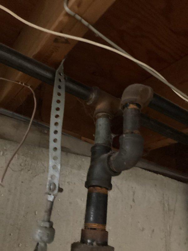 Responded to gas company-detected leak in basement gas line of 1960s-era home. Upon arrival, conducted thorough inspection of gas piping system and located source of leak at corroded black iron pipe joint. Heavily deteriorated fitting showed significant rust and oxidation at connection point, consistent with age of original installation. Confirmed leak location, documented condition of affected piping and surrounding gas line infrastructure with photographs. No odor detected at time of inspection as leak was localized to single compromised joint. Provided assessment of corroded gas line section and recommended repair options to address failed connection and prevent future issues.