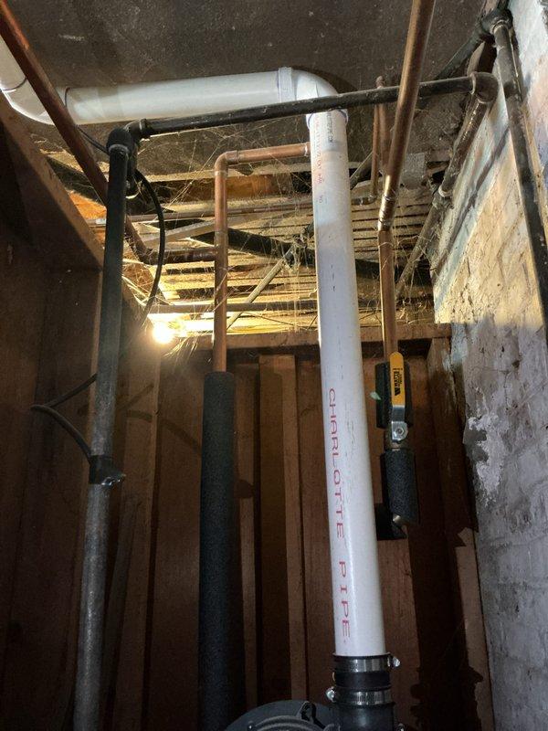 Completed rental inspection focusing on water heater and plumbing systems. Documented basement utility area including water heater unit with Energy Star rating, examined plumbing infrastructure consisting of copper supply lines, PVC drainage piping, and associated connections and valves, and assessed overall condition of mechanical systems and surrounding basement structure.