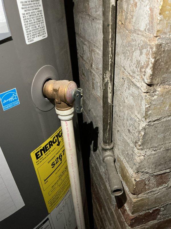 Completed rental inspection focusing on water heater and plumbing systems. Documented basement utility area including water heater unit with Energy Star rating, examined plumbing infrastructure consisting of copper supply lines, PVC drainage piping, and associated connections and valves, and assessed overall condition of mechanical systems and surrounding basement structure.