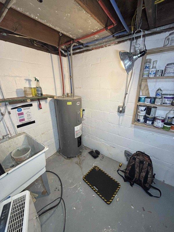 Responded to a 10-year-old residential water heater experiencing dual failure conditions: active leaking and complete loss of hot water production. Upon arrival, inspected the unit located in basement utility area and documented extensive rust staining on the concrete floor beneath the gas supply connection, indicating chronic water seepage from the lower tank section. Opened lower access panel to examine gas control valve, thermostat assembly, and burner components. Assessed internal wiring connections and gas valve operation. Based on the age of the unit, visible corrosion at the base, active leak evidence, and complete failure to heat water, determined the tank had reached end of useful service life with compromised structural integrity. Recommended complete water heater replacement as the most cost-effective and safe solution, as repairs would not address the underlying tank corrosion and leak source.