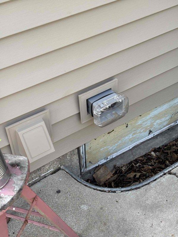 Completed 3-4 hours of exterior repairs addressing deteriorated wood trim and foundation board beneath vinyl siding. Removed severely weathered trim board showing extensive paint failure and wood deterioration, prepared surface area, and installed replacement materials. Work performed in vicinity of exterior electrical outlets and utility meter, ensuring proper clearances and weatherproofing upon completion.