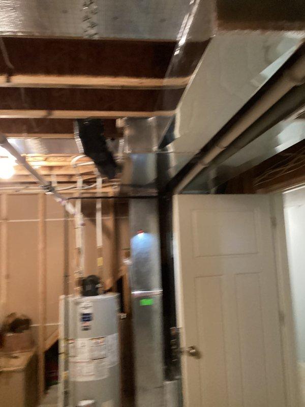 Responded to customer inquiry regarding temperature imbalance between floors. Inspected existing HVAC system and ductwork in basement utility area to assess feasibility of adding zoned system with additional thermostat for upstairs temperature control. Documented current system configuration and layout, photographing ductwork routing, basement infrastructure, and available space for potential zone damper installation. Provided consultation on zoning options to address comfort concerns.