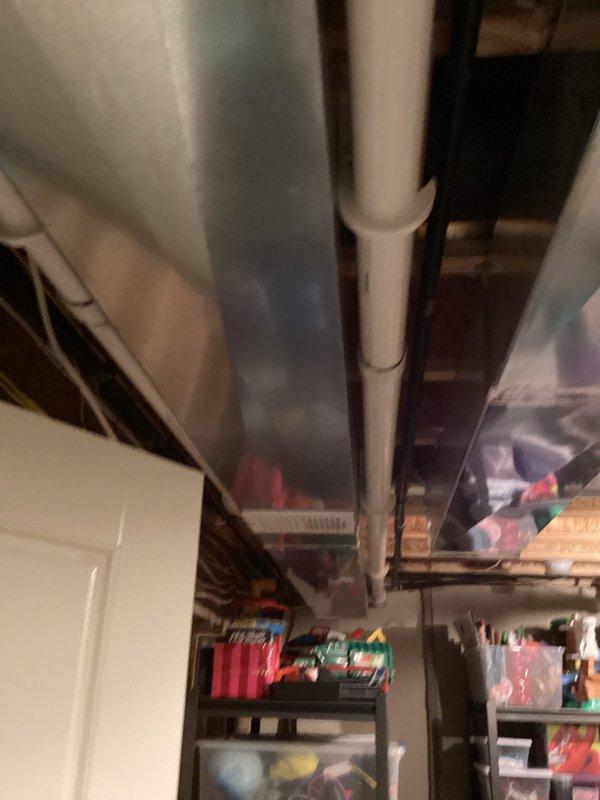 Responded to customer inquiry regarding temperature imbalance between floors. Inspected existing HVAC system and ductwork in basement utility area to assess feasibility of adding zoned system with additional thermostat for upstairs temperature control. Documented current system configuration and layout, photographing ductwork routing, basement infrastructure, and available space for potential zone damper installation. Provided consultation on zoning options to address comfort concerns.