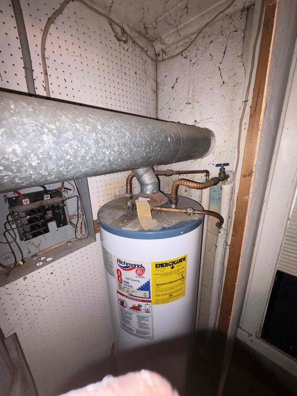 Responded to plumbing leak emergency in laundry room where frozen pipe had burst near water heater installation. Assessed damage to copper supply line, shut off water supply, and replaced damaged section of piping with new copper line and brass shutoff valve. Inspected water heater connections and surrounding plumbing for additional freeze damage, confirmed proper operation of pressure relief valve and corrugated flex connector, and restored water service to unit.