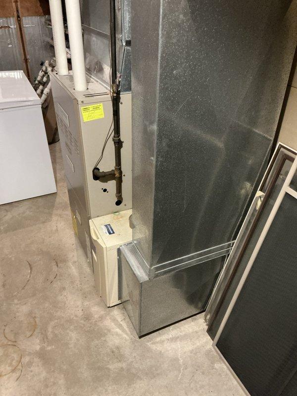 Conducted on-site assessment of 23-year-old residential air conditioning system to provide estimate for new condenser replacement. Evaluated existing HVAC equipment in basement utility area, including furnace, ductwork, and associated components. Documented current system configuration and captured photographic evidence of installation layout to support accurate equipment sizing and replacement specifications for whole-home cooling system in standard single-family residence.