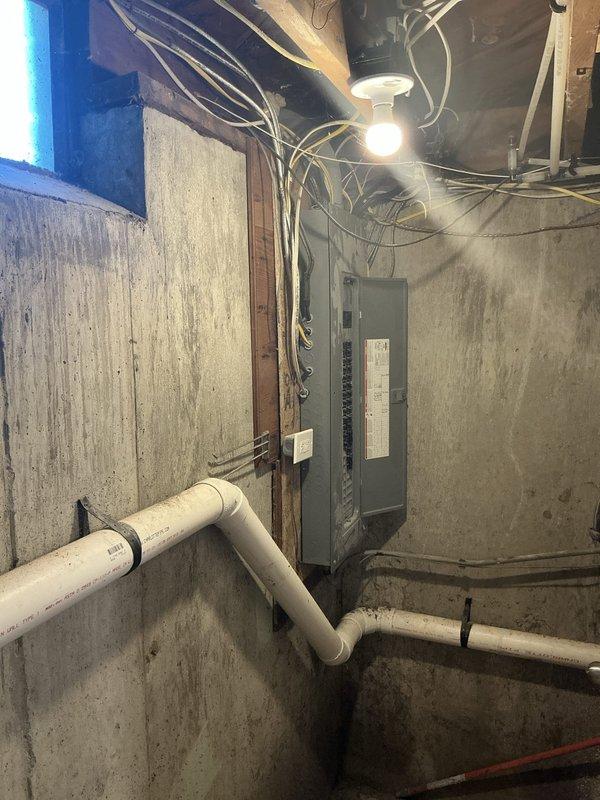 Conducted comprehensive site assessment for complete central air conditioning system installation at residential property with existing furnace system. Evaluated basement mechanical room infrastructure, electrical panel capacity, and exterior wall conditions to determine optimal equipment placement and refrigerant line routing. Documented existing utility configurations, foundation waterproofing, and structural considerations necessary for proper AC condenser placement and condensate drainage planning.