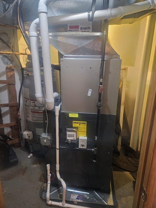 Completed full add-on air conditioning system installation to existing forced-air heating system. Installed new Carrier outdoor condensing unit on concrete pad with proper clearances and electrical disconnect. Ran refrigerant lines and established connections to new evaporator coil integrated with existing furnace system. Installed all necessary ductwork modifications, drainage piping, and PVC condensate lines. System tested, charged to manufacturer specifications, and verified operational with proper airflow and temperature differentials across coil.