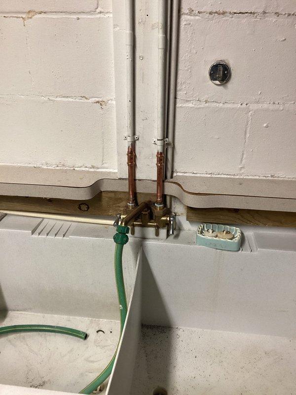 Completed plumbing project estimate for faucet replacement and additional plumbing repairs. Assessed utility sink installation with aging copper supply lines, brass compression fittings, and shut-off valves requiring attention. Documented existing HVAC equipment connections and plumbing infrastructure in mechanical room area, including PVC to copper pipe transitions and associated fixtures requiring service.