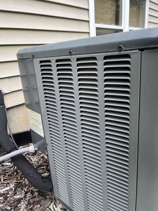 Completed annual cooling maintenance on 6-year-old EnergiAir outdoor condensing unit with warranty through July 2029. Performed comprehensive tune-up including inspection of exterior cabinet condition, verification of proper airflow through louvered panels, and documentation of system operating on concrete pad with adequate clearance. Unit found in good operating condition with clean exterior finish and properly secured top cover.