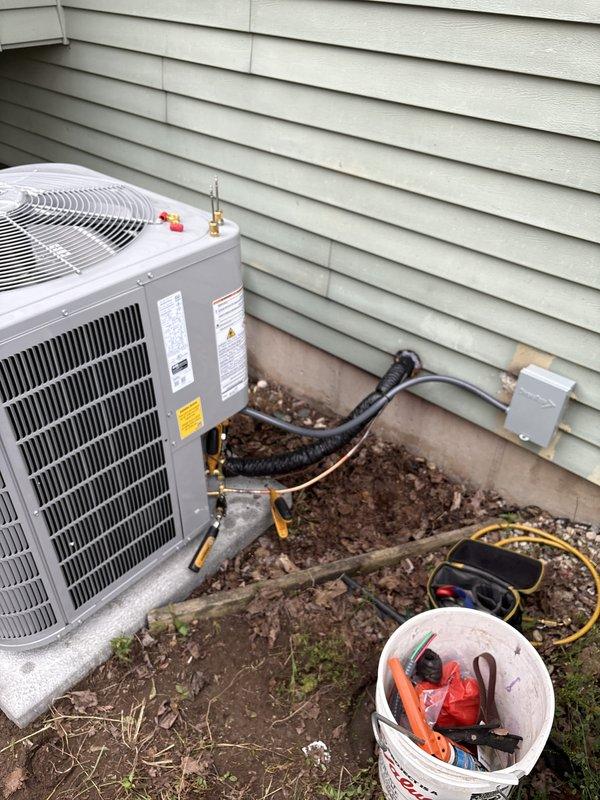 Completed full HVAC system replacement including outdoor condensing unit and indoor Amana furnace. Installed new refrigerant lines with proper insulation, electrical disconnect box, and connected all refrigerant piping with brass fittings. Established complete ductwork connections, PVC venting system, and verified all electrical connections to code. System tested and operational upon completion.
