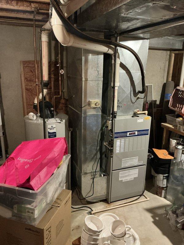 Conducted comprehensive assessment of existing Heil brand furnace and air conditioning system in residential basement mechanical room. Customer reported AC operational but furnace not functioning properly. Performed detailed inspection of furnace unit, including examination of manufacturer labels, ventilation systems, electrical connections, and PVC vent piping. Documented current equipment condition and configuration, noting all mechanical connections, ductwork, and utility interfaces. Provided estimate for furnace and AC replacement options based on system evaluation and customer needs.
