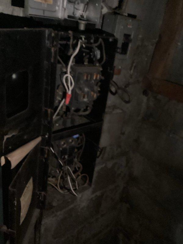 Responded to electrical service call for residence with stolen wiring that rendered property uninhabitable. Conducted comprehensive assessment of electrical system and documented extensive wire theft damage throughout the structure. Inspected basement utility area and mechanical room, examining compromised electrical infrastructure including missing conductors from HVAC equipment, heating systems, and main distribution points. Photographed affected areas showing exposed equipment, damaged wiring connections, and vacant conduit runs where copper conductors had been removed. Documented conditions for insurance claim purposes, capturing evidence of theft-related electrical system damage that would require complete rewiring to restore power and habitability to the residence.