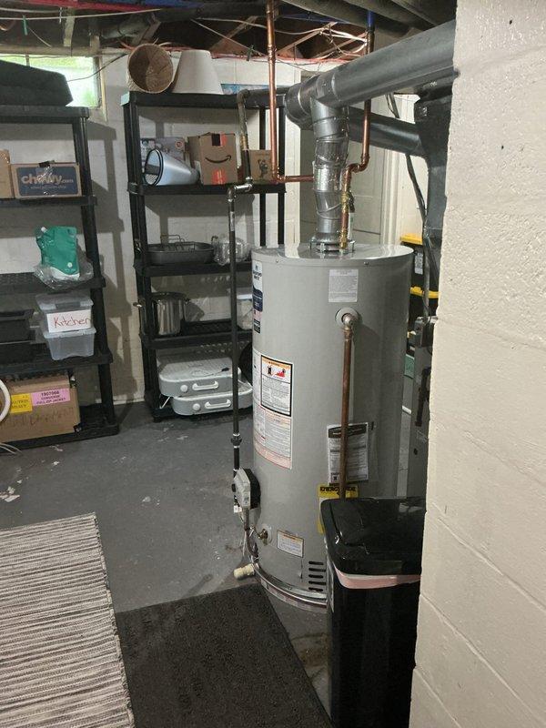 Completed installation of 40-gallon natural gas water heater in basement utility area. Unit was installed with proper venting through PVC piping system and connected to existing copper supply lines. All connections were secured, system was tested for proper operation, and installation meets code requirements for residential water heating applications.