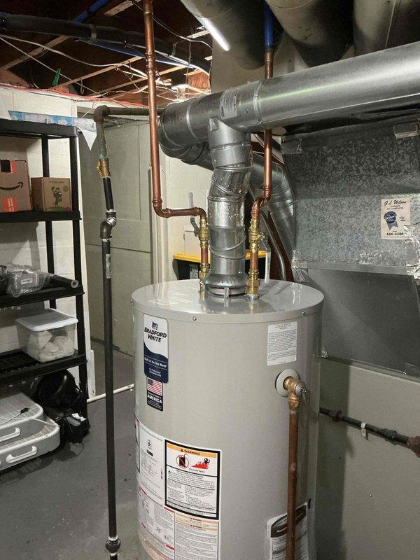 Completed installation of 40-gallon natural gas water heater in basement utility area. Unit was installed with proper venting through PVC piping system and connected to existing copper supply lines. All connections were secured, system was tested for proper operation, and installation meets code requirements for residential water heating applications.