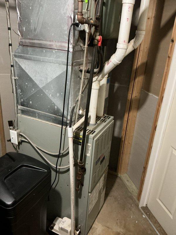 Completed annual cooling system maintenance and tune-up on residential HVAC unit located in basement mechanical room. Performed comprehensive inspection of furnace and air conditioning components, checked all electrical connections, tested system operation, and verified proper drainage through PVC condensate lines. All equipment found to be functioning within normal parameters with routine cleaning and adjustments completed as part of preventative maintenance protocol.
