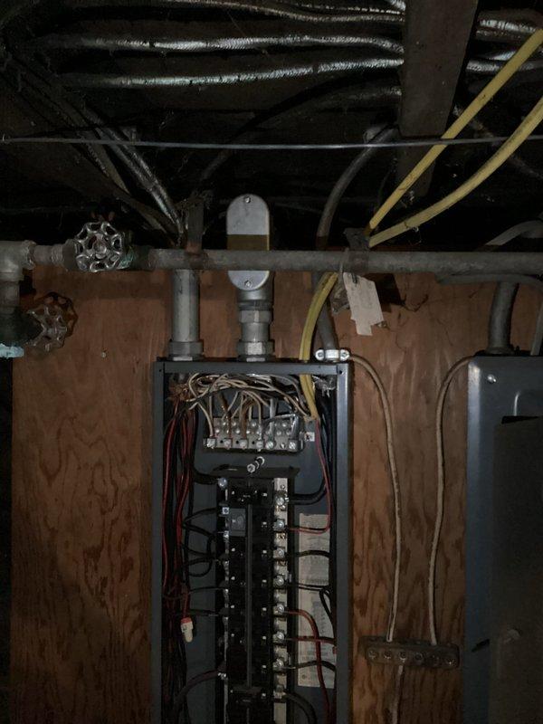 Conducted electrical estimate for new electrical line installation in residential property. Documented existing electrical panel configurations in basement and attic locations, photographing current circuit breaker arrangements, conduit routing, and wire management systems to assess scope of work required for additional electrical service lines. Identified panel capacities, available breaker slots, and optimal pathways for new circuit installation through unfinished utility spaces.