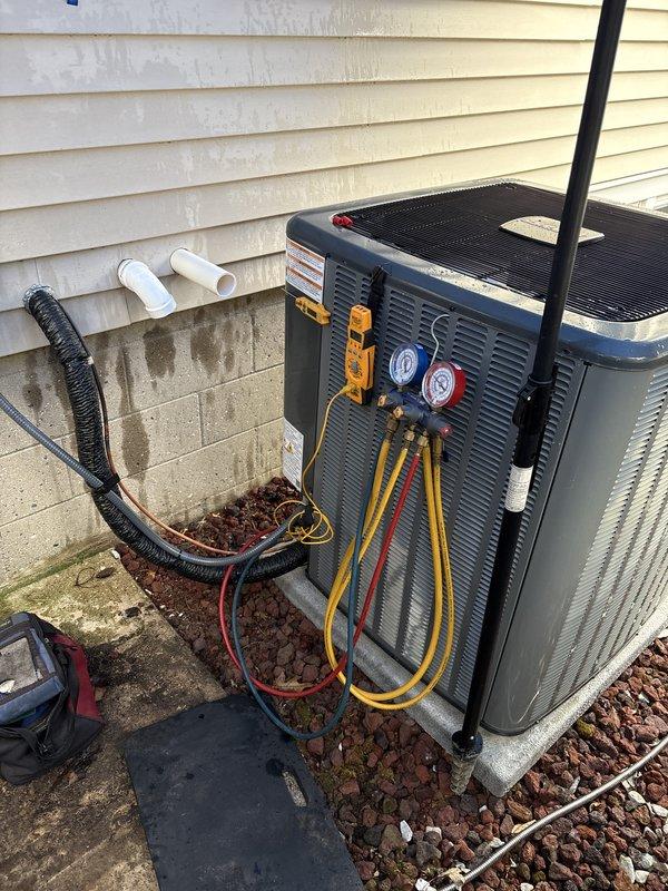 Completed full air conditioning system replacement including outdoor condenser unit and indoor air handler. Installed new condenser on existing concrete pad with proper refrigerant line connections, verified system charge using manifold gauges, and confirmed proper drainage through existing PVC condensate lines. Indoor air handler installed in basement mechanical room with integration to existing ductwork and electrical connections. System tested and operational with proper airflow and temperature differential confirmed.