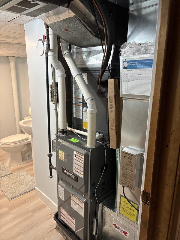Completed full air conditioning system replacement including outdoor condenser unit and indoor air handler. Installed new condenser on existing concrete pad with proper refrigerant line connections, verified system charge using manifold gauges, and confirmed proper drainage through existing PVC condensate lines. Indoor air handler installed in basement mechanical room with integration to existing ductwork and electrical connections. System tested and operational with proper airflow and temperature differential confirmed.