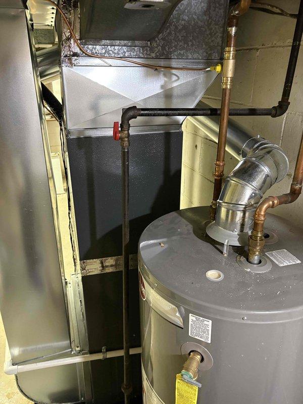Completed full installation of new furnace and air conditioning system in residential mechanical room. Installed HVAC unit with proper refrigerant line connections, ductwork integration, and condensate drainage system. All equipment mounted and secured per manufacturer specifications, copper piping installed with appropriate fittings and shutoff valves, and system tested for proper operation upon completion.