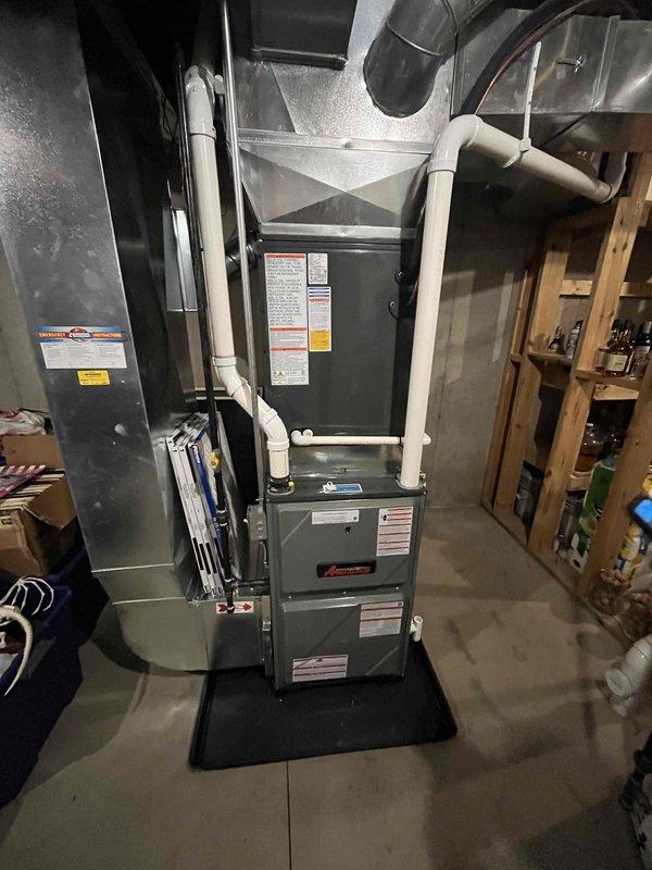 Completed full HVAC system replacement in residential basement utility room. Removed existing equipment and installed new furnace unit with proper venting configuration using white PVC piping for condensate drainage and combustion air intake. Connected metal ductwork and plenum to air handler, ensuring proper airflow distribution throughout the home. Positioned equipment on protective mat over concrete floor with appropriate clearances for service access. Routed all venting, drainage lines, and flexible ductwork per manufacturer specifications and local building codes. Verified all connections are secure, labeled equipment appropriately with safety and specification tags, and confirmed system operates within normal parameters. Installation completed as same-day service with financing arrangements processed.