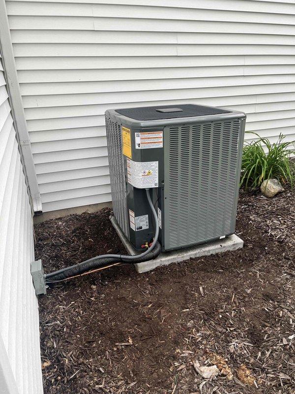 Completed full air conditioning system replacement including outdoor condenser unit and indoor air handler components. New condenser installed on existing concrete pad with proper refrigerant line connections, electrical conduit routing through exterior wall, and secure mounting to manufacturer specifications. Indoor HVAC equipment integrated with existing ductwork system, ensuring proper airflow distribution and system compatibility. All connections tested, system charged, and operational verification performed to confirm cooling capacity and efficient operation.