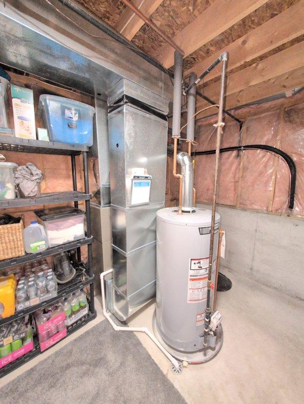 Completed full installation of new residential furnace and air conditioning system. Installed outdoor condensing unit on concrete pad with proper refrigerant charging and pressure testing using manifold gauges to verify system performance. Installed new furnace unit in basement mechanical room with appropriate venting and gas connections, ensuring all equipment is properly positioned and operational alongside existing water heater.