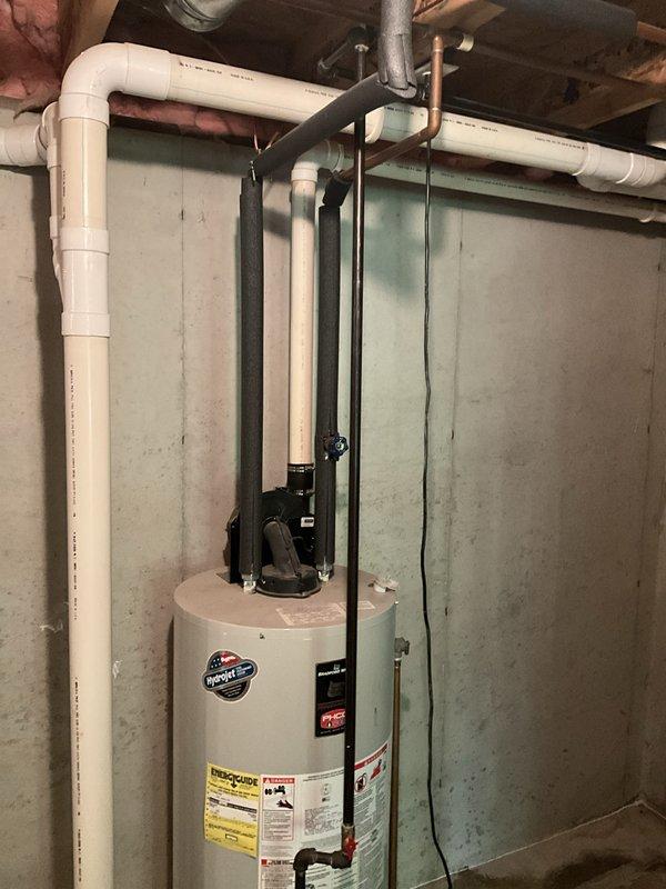 Completed annual cooling system maintenance and inspection. Upon arrival, also investigated reported water dripping from water heater in basement. Inspected Bradford White water heater unit, associated plumbing connections, PVC piping, copper lines, and flue venting system. Documented equipment condition with photographs showing no active leaks present at time of inspection, though monitored all connections, drain pan, and temperature/pressure relief valve discharge piping for potential moisture sources.