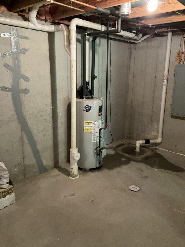 Completed annual cooling system maintenance and inspection. Upon arrival, also investigated reported water dripping from water heater in basement. Inspected Bradford White water heater unit, associated plumbing connections, PVC piping, copper lines, and flue venting system. Documented equipment condition with photographs showing no active leaks present at time of inspection, though monitored all connections, drain pan, and temperature/pressure relief valve discharge piping for potential moisture sources.