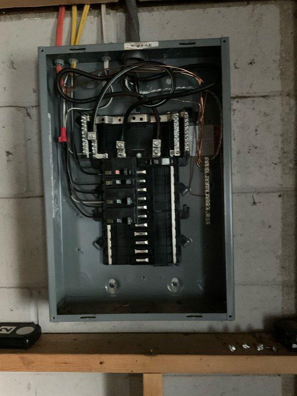 Conducted electrical system assessment and documentation at residential property. Performed comprehensive inspection of main electrical panel, photographing existing configuration including circuit breaker arrangement, wire routing, and service entrance connections. Panel evaluation revealed multiple branch circuits with romex wiring entering through top access point along with main service conduit. Documented current electrical infrastructure for future upgrade planning and code compliance review.