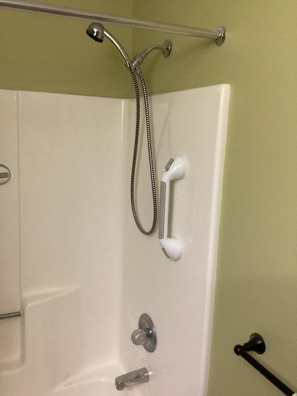 Responded to service call for malfunctioning shower diverter stuck in shower position and broken showerhead. Successfully repaired diverter mechanism to restore proper function between tub spout and showerhead, and replaced damaged handheld showerhead unit with new chrome fixture mounted on existing slide bar assembly.