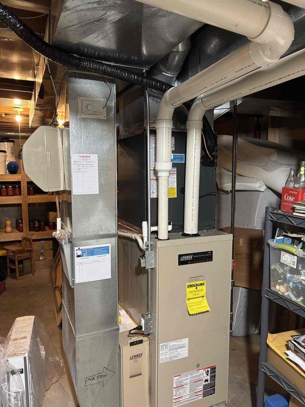 Successfully completed full air conditioning system replacement in basement utility area. Removed existing AC unit and installed new Lennox system with proper ductwork connections, including metallic plenum assembly and insulated supply ducts. Configured PVC condensate drain lines and venting according to manufacturer specifications. Verified all electrical connections, tested system operation, and ensured proper airflow throughout the distribution network. Installation includes complete labeling per code requirements and integrated seamlessly with existing furnace infrastructure.