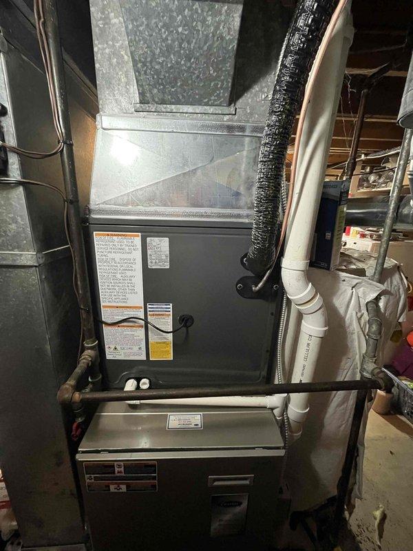 Completed full HVAC system replacement including outdoor condensing unit and indoor air handling equipment. Removed existing system and installed new air conditioning condenser on concrete pad at exterior of residence with proper refrigerant line connections and electrical hookup. Installed new indoor air handler and furnace assembly in basement utility area with ductwork integration, condensate drainage via PVC piping, and electrical connections. Verified proper system operation, refrigerant charge, airflow, and all safety controls. All equipment secured, labeled, and tested for optimal performance.